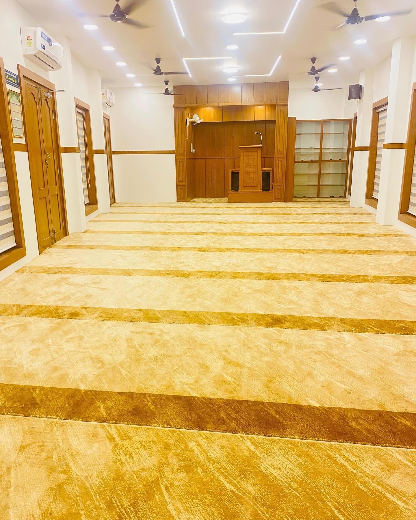 Luxurious red masjid carpet installed in a grand mosque in Kerala